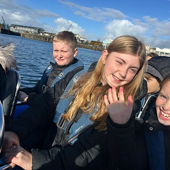 Children wearing life jackets on a boat trip