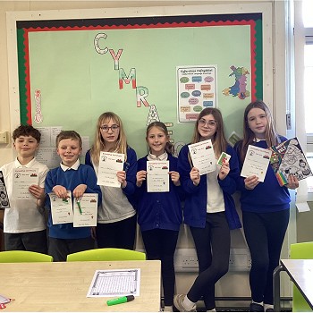 students holding their certificates