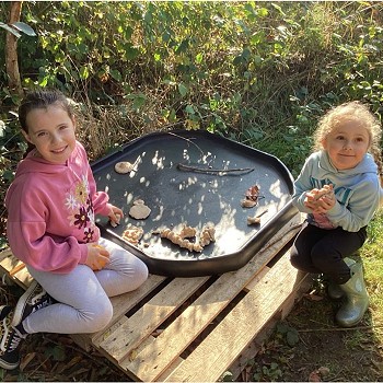 2 students playing with things outdoors